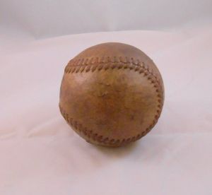 No other notable markings can be seen on the baseball. This is a common WWII U.S. military baseball.
